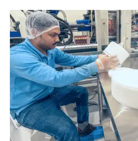 Person inspecting plastic buckets